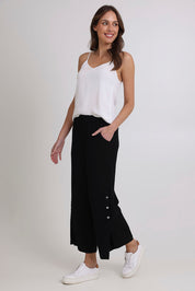 Model Madeline wearing size 10 of the Linen Shores Pant in colour Black (Black), from the front, showing the whole outfit