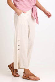 Model Madelinec wearing size 10 of the Linen Shores Pant – Sand in colour Sand, from an angle