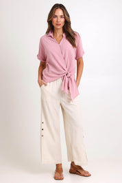 Model Madelinec wearing size 10 of the Linen Shores Pant – Sand in colour Sand, from the front