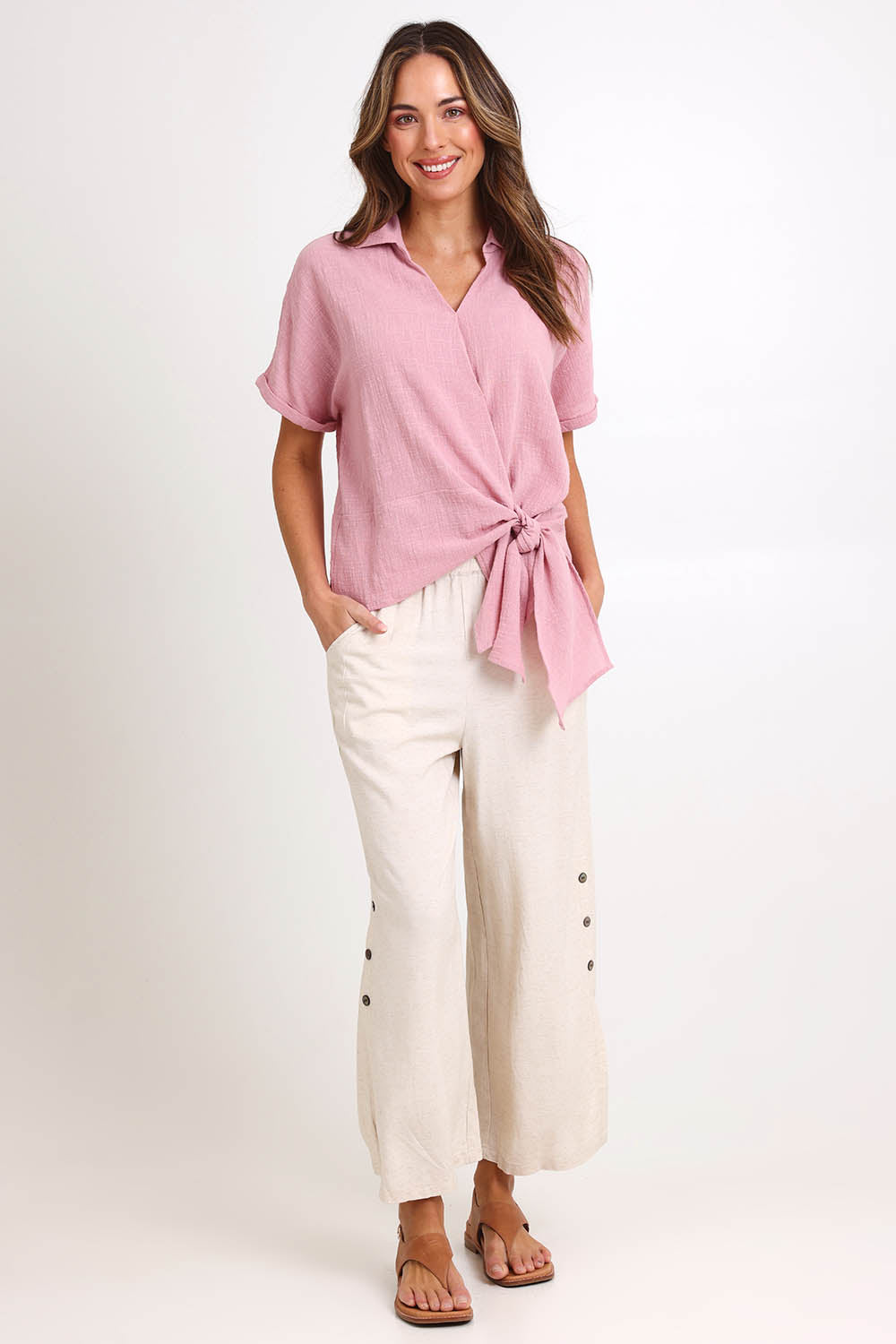 Model Madelinec wearing size 10 of the Linen Shores Pant – Sand in colour Sand, from the front