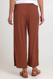 Model Madelinec wearing size 10 of the Linen Shores Pant – Toffee in colour Toffee, from the back
