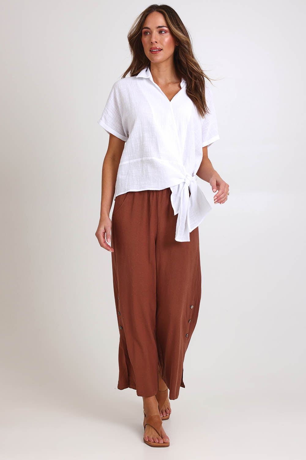 Model Madelinec wearing size 10 of the Linen Shores Pant – Toffee in colour Toffee, from the front