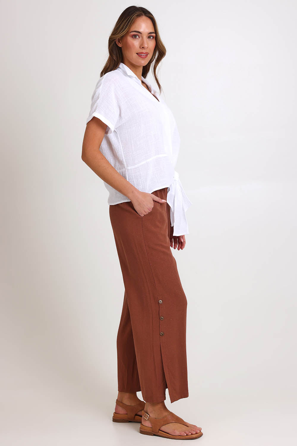 Model Madelinec wearing size 10 of the Linen Shores Pant – Toffee in colour Toffee, from the front