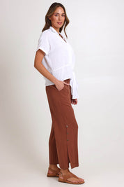 Model Madelinec wearing size 10 of the Linen Shores Pant – Toffee in colour Toffee, from the front