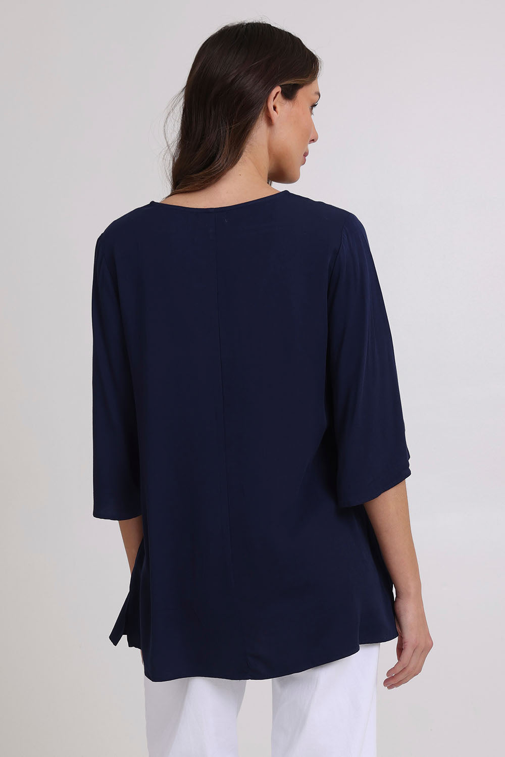 Model Madeline wearing size 10 of the Florida Kaftan Tunic Top in colour Navy (Blue), from the back
