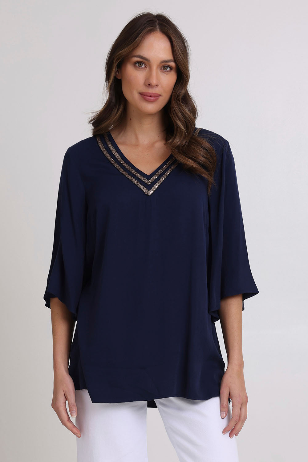 Model Madeline wearing size 10 of the Florida Kaftan Tunic Top in colour Navy (Blue), from the front, cropped image