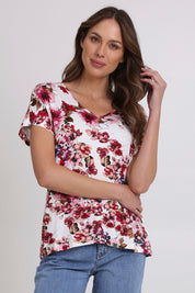 Model Madeline wearing size 10 of the Perfect Vee Tee in colour Floral (Pink), from the front, cropped image