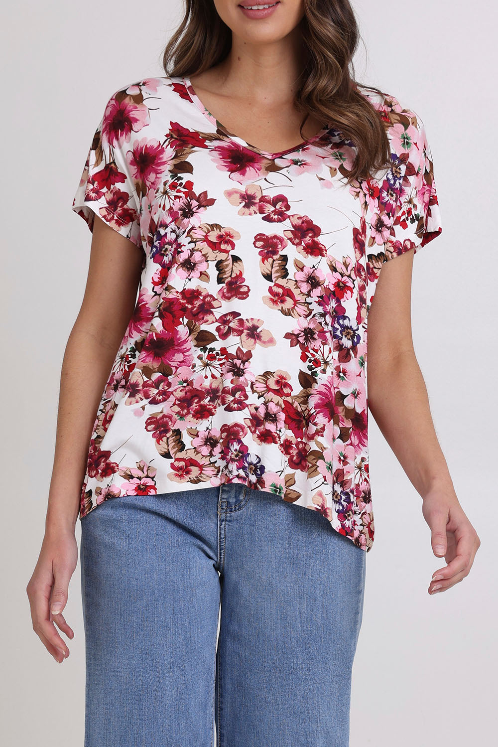 Model Madeline wearing size 10 of the Perfect Vee Tee in colour Floral (Pink), from the front, cropped image