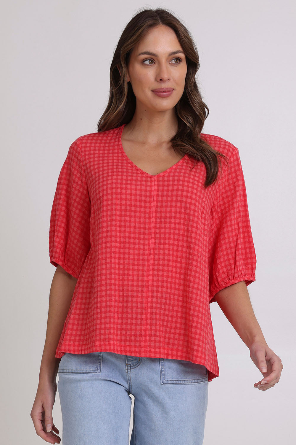 Model Madeline wearing size 10 of the Victoria Textured Cotton Blend Top in colour Coral (Pink), from the front, cropped image