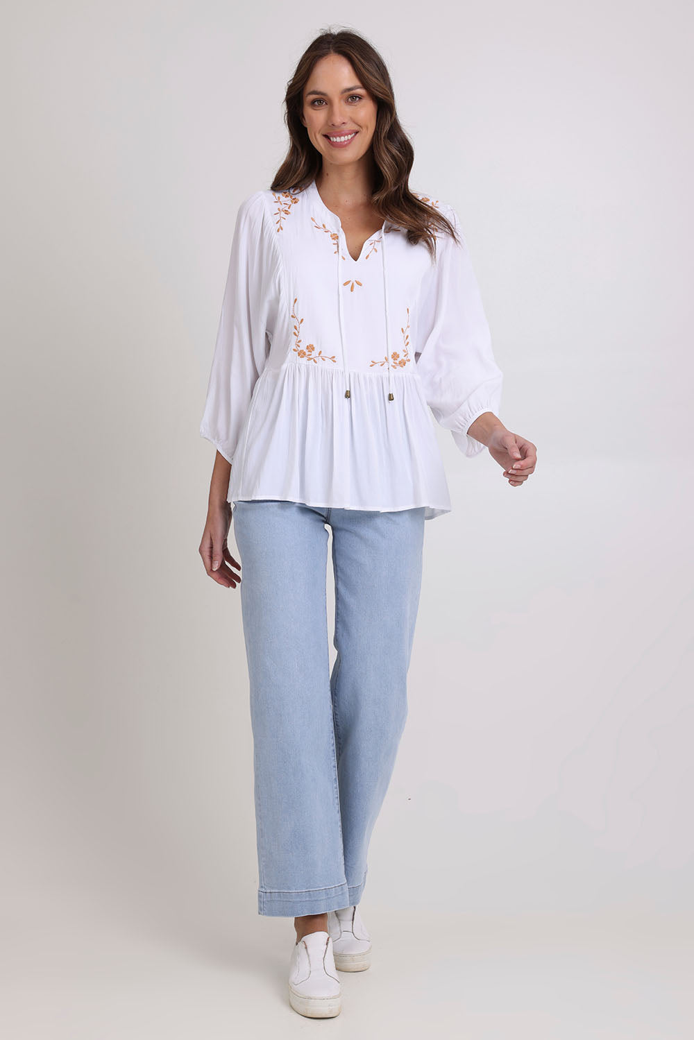 Model Madeline wearing size 10 of the Bombay Beauty Top in colour White (White), from the front, showing the whole outfit