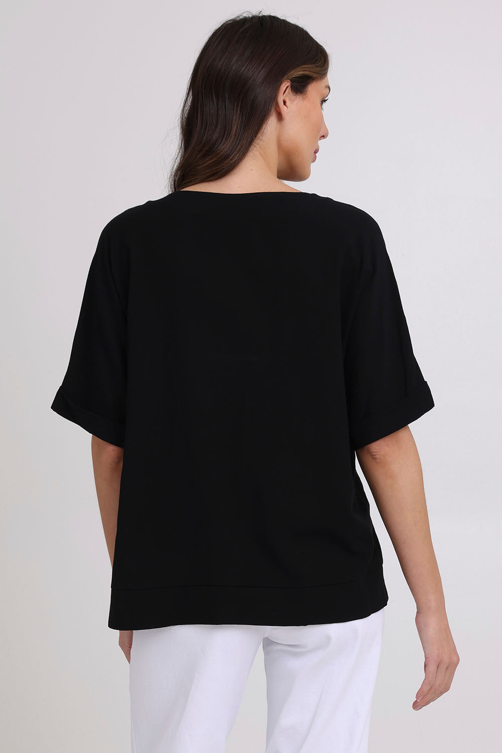 Model Madeline wearing size 10 of the Linen Shores Top in colour Black (Black), from the back
