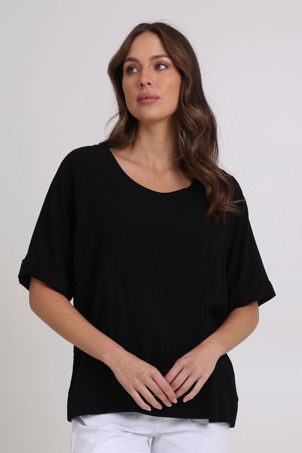 Model Madeline wearing size 10 of the Linen Shores Top in colour Black (Black), from the front, cropped image