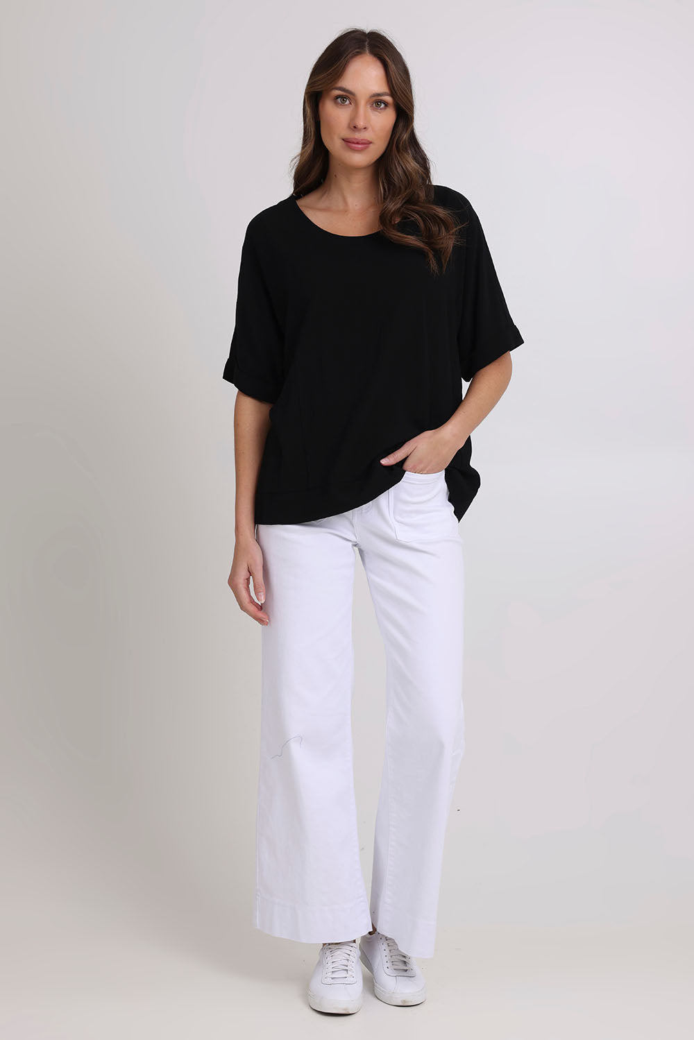 Model Madeline wearing size 10 of the Linen Shores Top in colour Black (Black), from the front, showing the whole outfit