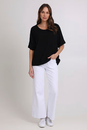 Model Madeline wearing size 10 of the Linen Shores Top in colour Black (Black), from the front, showing the whole outfit