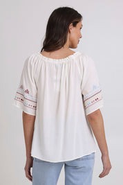 Model Madeline wearing size 10 of the Oakley Embroidered Top in colour Ivory (White), from the back