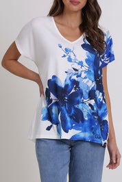 Model Madeline wearing size 10 of the Blue Beauty Tee in colour Blue (White), from the front, cropped image