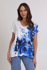 Model Madeline wearing size 10 of the Blue Beauty Tee in colour Blue (White), from the front, cropped image