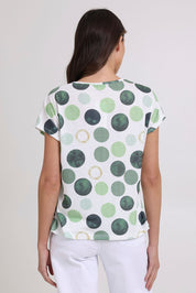 Model Madeline wearing size 10 of the Spotty Dotty Cap Sleeve Top in colour Whitegrn (Green), from the back