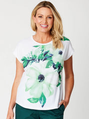 A model wearing the Green Goddess Scoop Tee in colour Green (Green), from the front, showing the whole outfit
