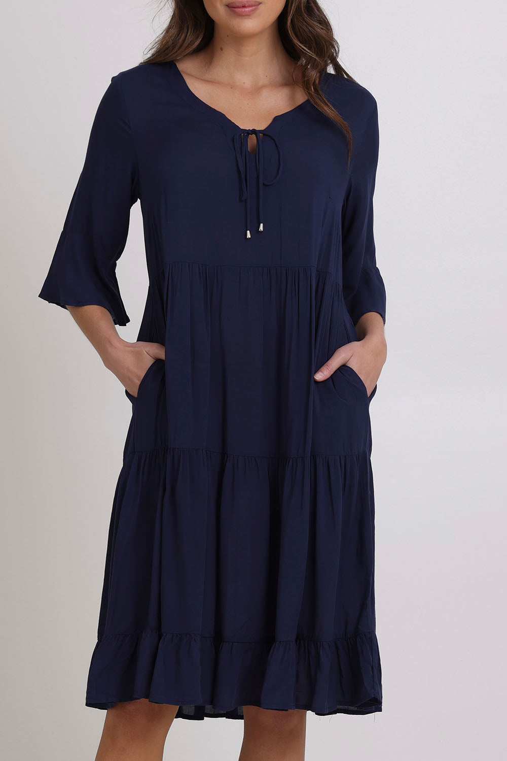 Model Madeline wearing size 10 of the Jessie Dress in colour Navy (Blue), from the front, cropped image