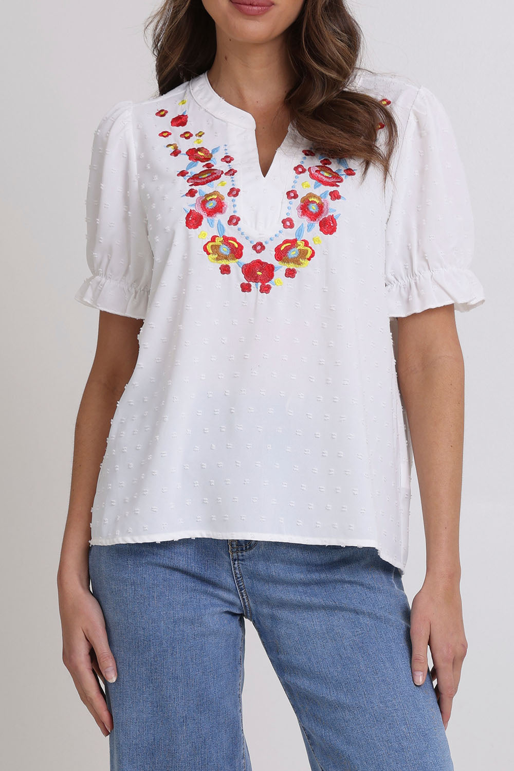 Model Madeline wearing size 10 of the Embroidered Dobi Top in colour White (White), from the front, cropped image