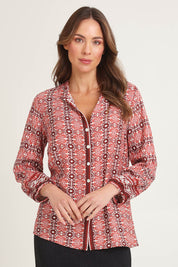 Model Madeline wearing size 10 of the Vera Button Shirt in colour Russet (Red), from the front, cropped image