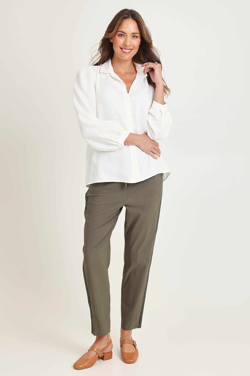 Model Madeline wearing size 10 of the Core Season Top in colour White (White), from the front, showing the whole outfit