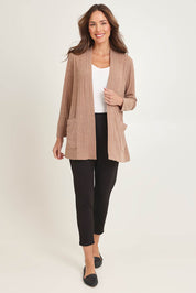 Model Madeline wearing size 10 of the Knit Core Cardy in colour Beige, from the front, showing the whole outfit