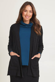 Model Madeline wearing size 10 of the Knit Core Cardy in colour Black (Black), from the front, cropped image