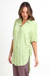 Model Madelinec wearing size 10 of the Drawstring Tunic Shirt – Sage in colour Sage, in a cropped view