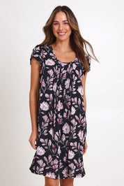 Model Madelinec wearing size 10 of the Kirra Pintuck Dress – Blkfloral in colour Blkfloral, in a cropped view