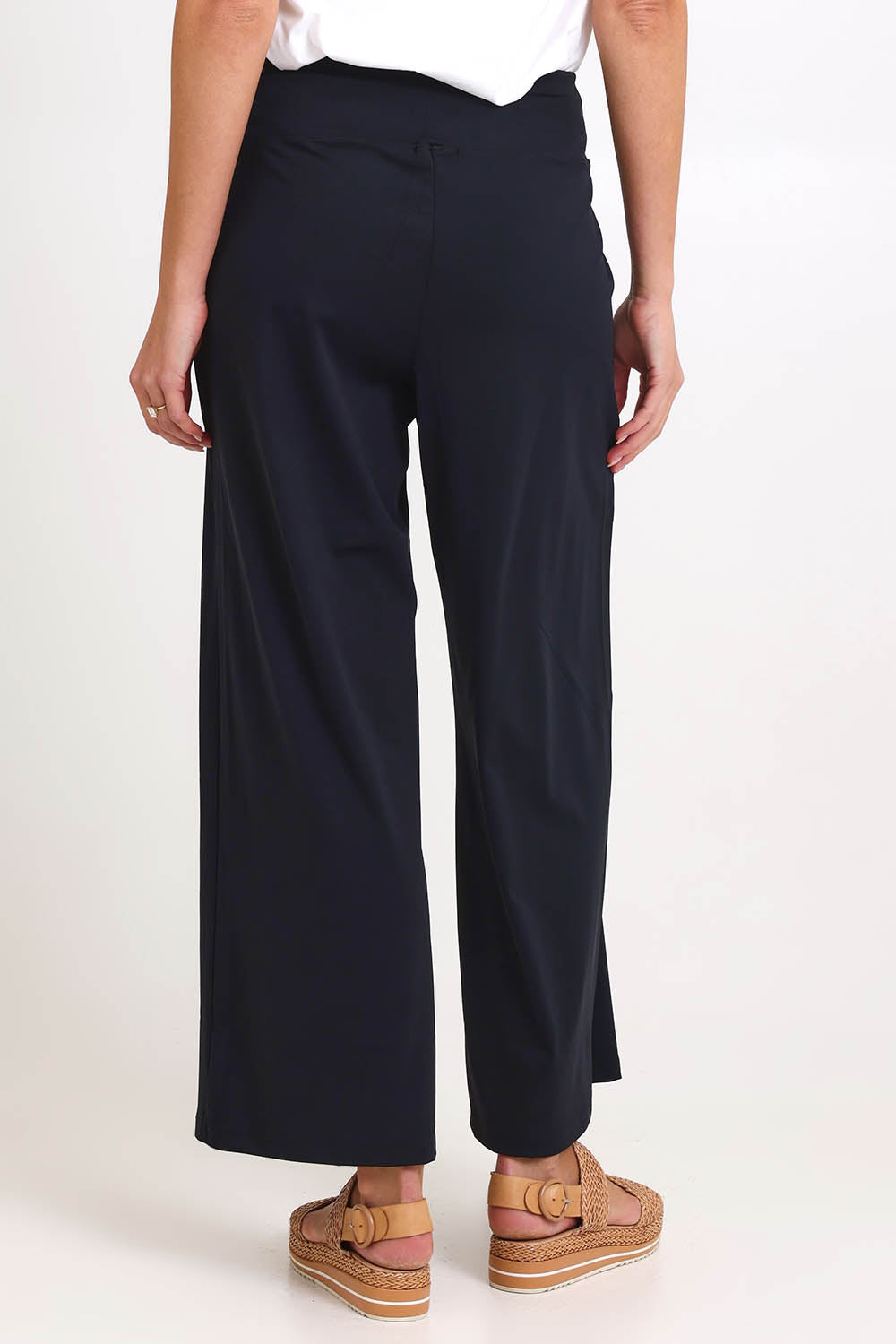 Model Madelinec wearing size 10 of the Walk And Work Pant – Black in colour Black, from the back