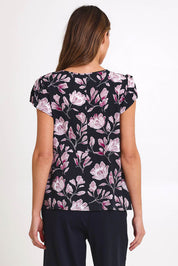 Model Madelinec wearing size 10 of the Kirra Pintuck Top – Blkfloral in colour Blkfloral, from the back