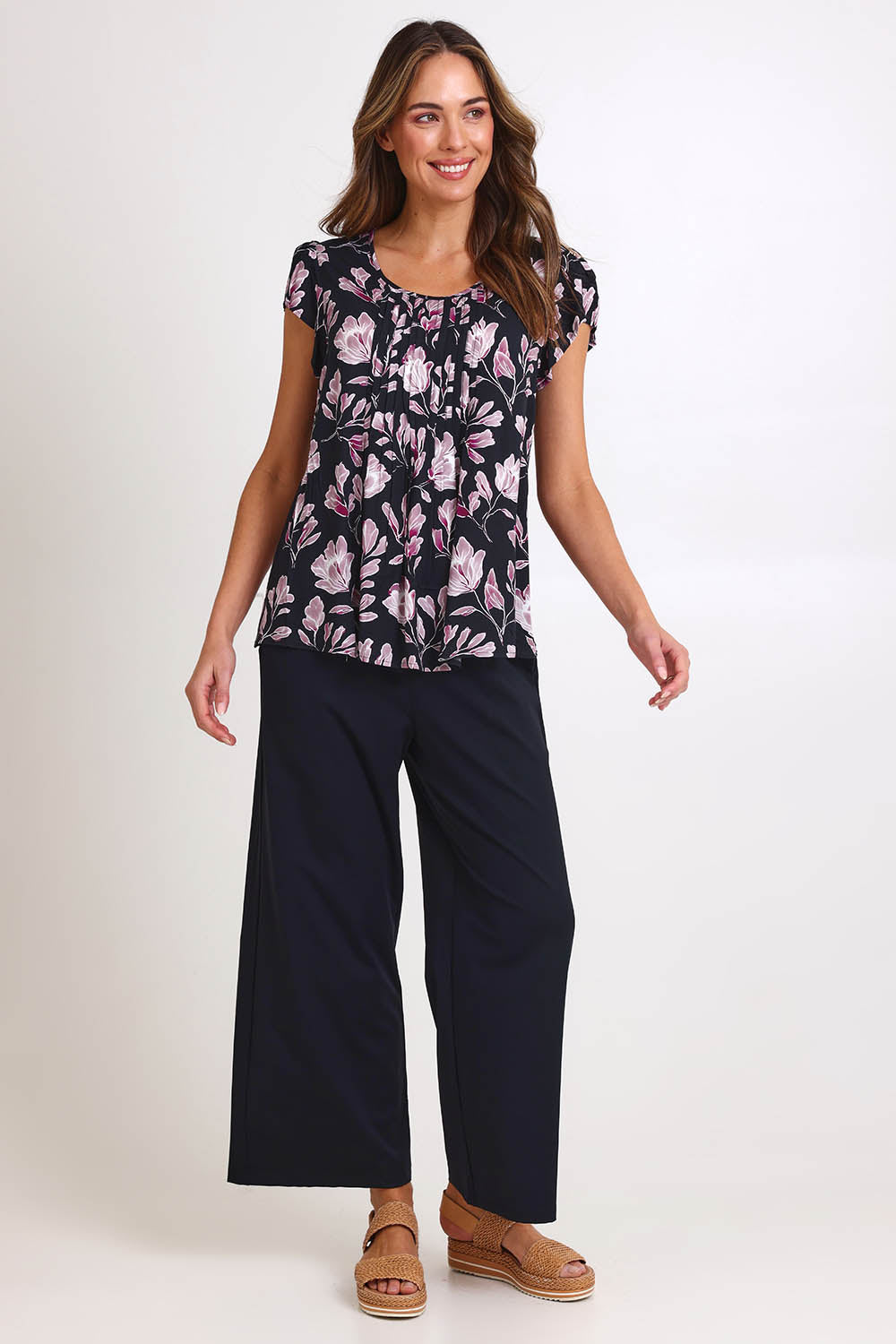 Model Madelinec wearing size 10 of the Kirra Pintuck Top – Blkfloral in colour Blkfloral, from the front