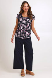 Model Madelinec wearing size 10 of the Kirra Pintuck Top – Blkfloral in colour Blkfloral, from the front