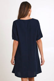 Model Madelinec wearing size 10 of the Core Linen V Shift Dress – Navy in colour Navy, from the back