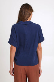 Model Madelinec wearing size 10 of the Core Wrap Over Top – Navy in colour Navy, from the back