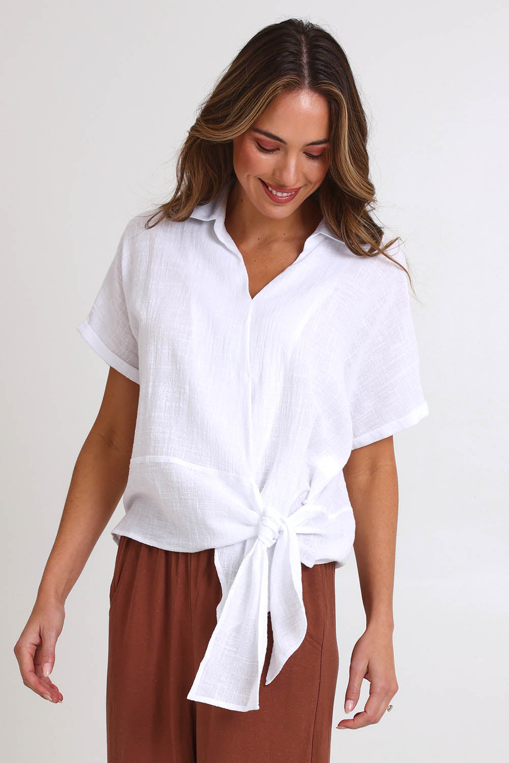 Model Madelinec wearing size 10 of the Core Wrap Over Top – White in colour White, in a cropped view