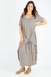 Model Shadae wearing size S-M of the Primrose Dress in colour Oatmeal, from the front, showing the whole outfit