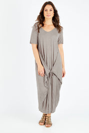 Model Shadae wearing size S-M of the Primrose Dress in colour Oatmeal, from the front, showing the whole outfit