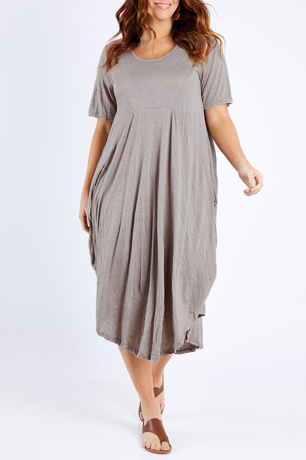 Model Laura wearing size M-L of the In Bloom Flowing Dress in colour Oatmeal, from the front, showing the whole outfit