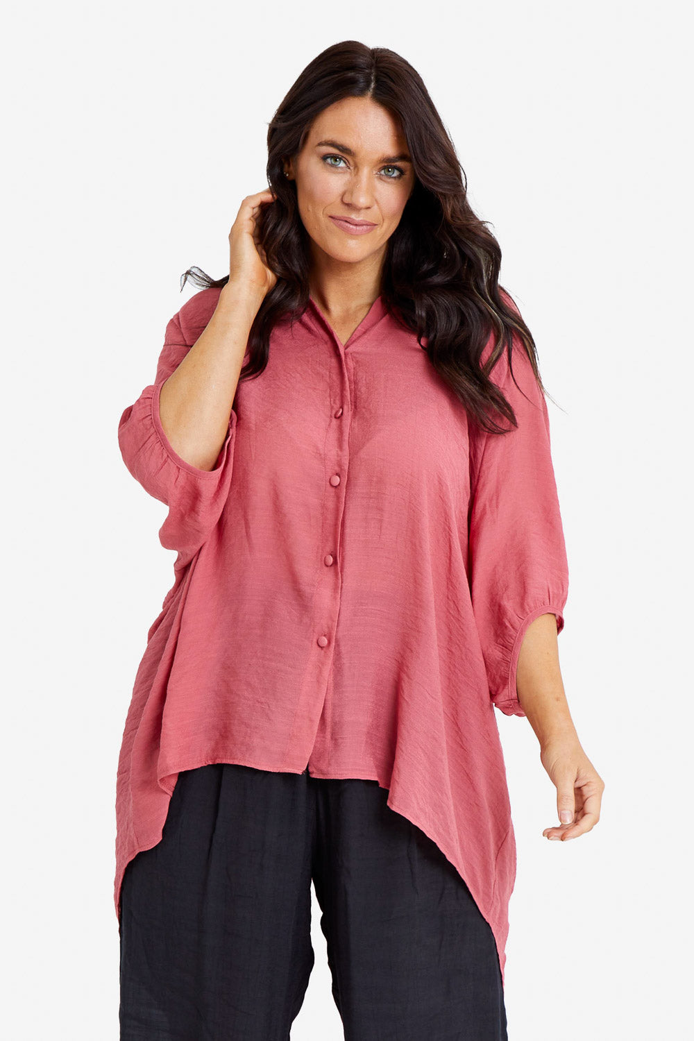 Model Laura wearing size M-L of the Snowbell Flowy Shirt in colour Clay (Pink), from the front, cropped image