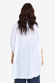 Model Laura wearing size M-L of the Snowbell Flowy Shirt in colour White (White), from the back