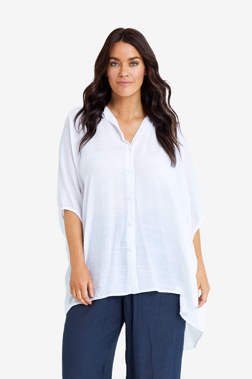 Model Laura wearing size M-L of the Snowbell Flowy Shirt in colour White (White), from the front, cropped image
