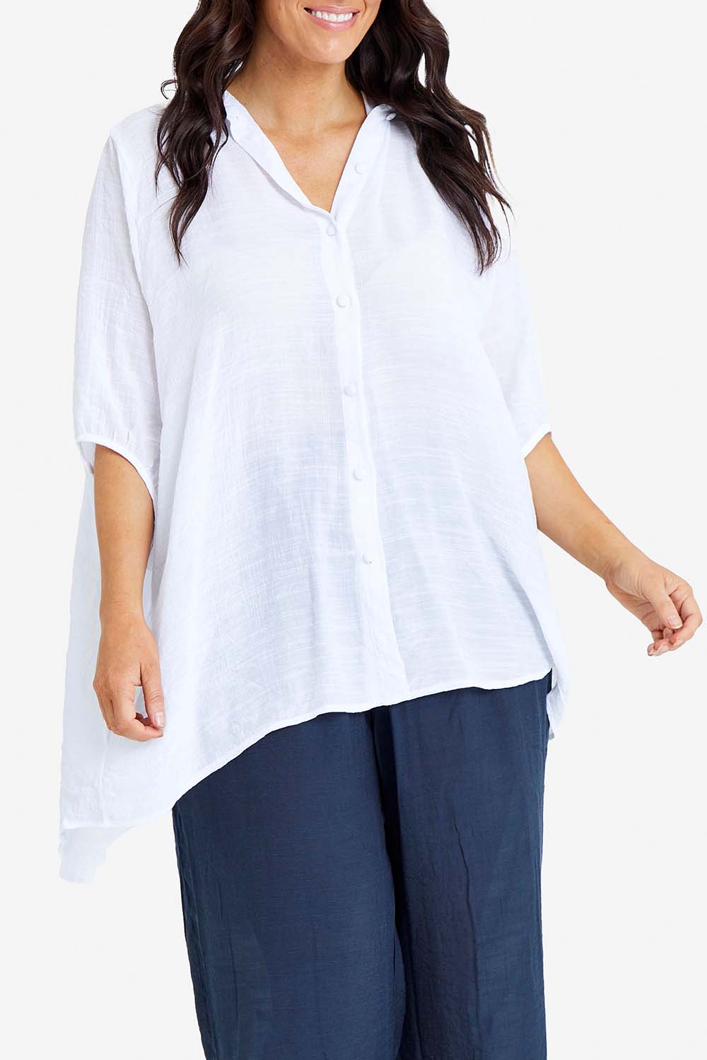 Model Laura wearing size M-L of the Snowbell Flowy Shirt in colour White (White), from the front, cropped image