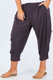 Model Fiona wearing size M-L of the Poppy Pant in colour Charcoal (Grey), from the front, cropped image