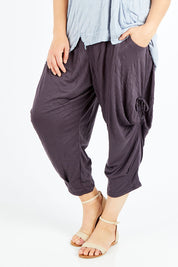 Model Shadae wearing size S-M of the Poppy Pant in colour Charcoal (Grey), from the front, cropped image