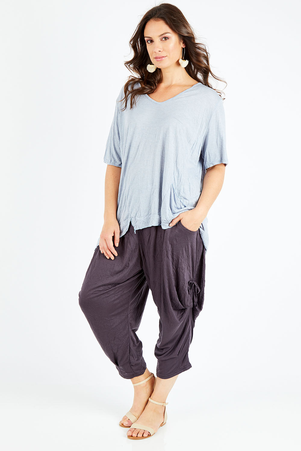 Model Shadae wearing size S-M of the Poppy Pant in colour Charcoal (Grey), from the front, showing the whole outfit