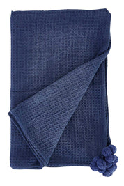 Product shot of the Textured Cotton Throw With Pompoms in colour Navy (Blue), from the front