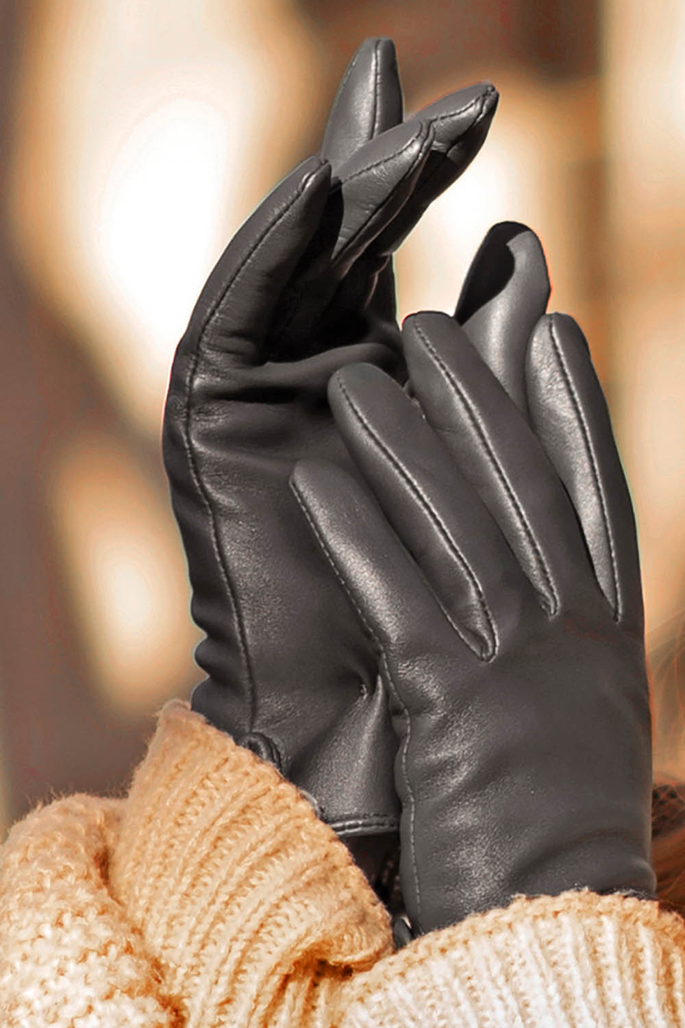 A model wearing the Classic Leather Gloves in colour Black (Black), from the front, showing the whole outfit